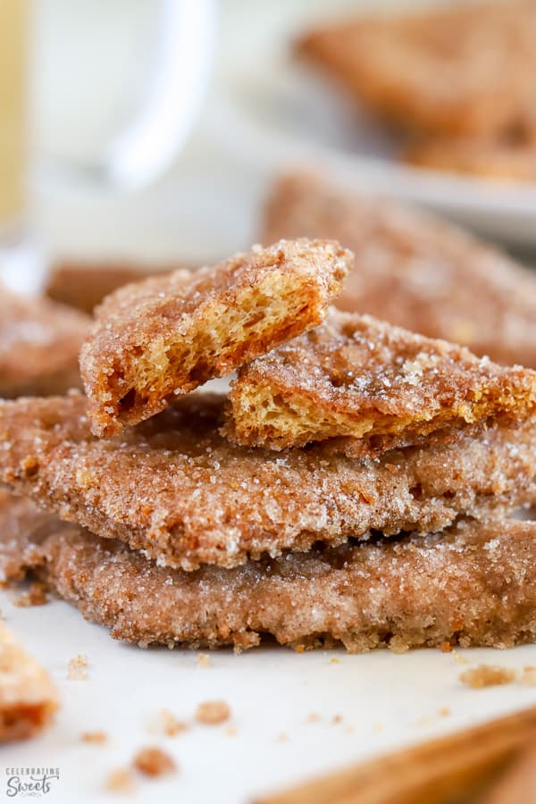 Stack of cinnamon cookies on parchment paper.