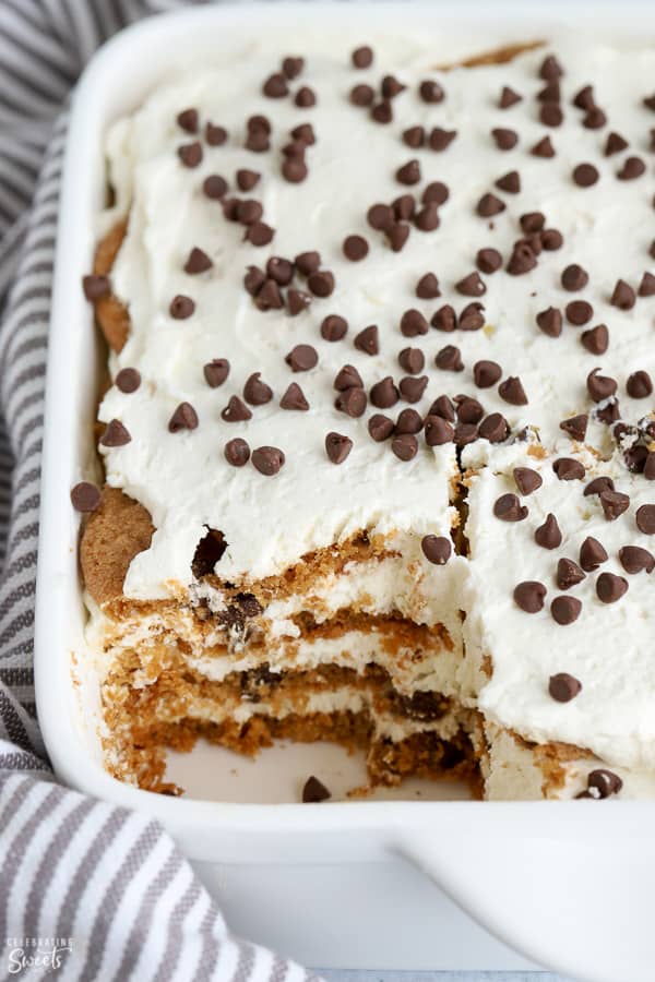Cookies layered with whipped cream in a white baking dish.
