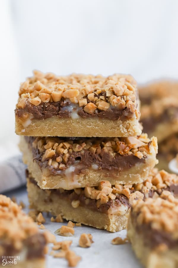 Stack of three toffee bars topped with chocolate and toffee bits,