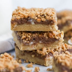 Stack of three toffee bars topped with chocolate and toffee bits,
