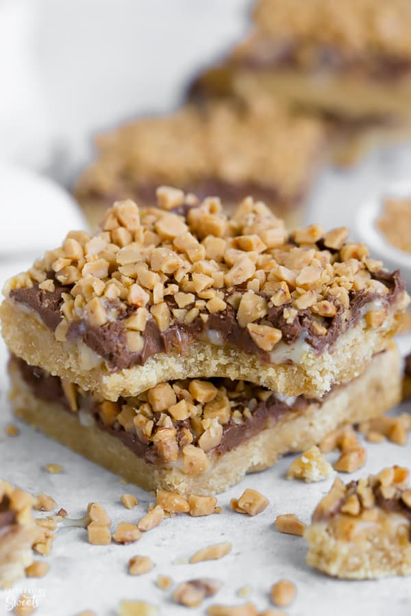Two cookie bars topped with chocolate and toffee bits.