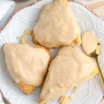 Three maple scones on a plate.
