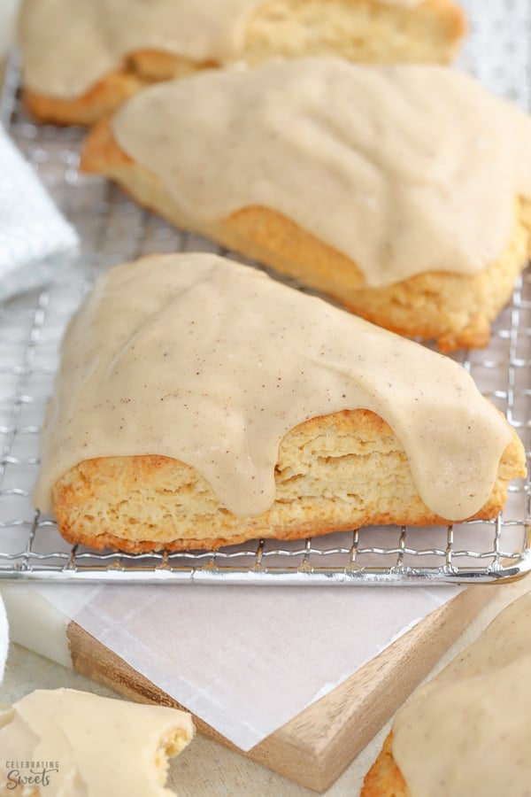 Maple scones covered in glaze on a wire rack.