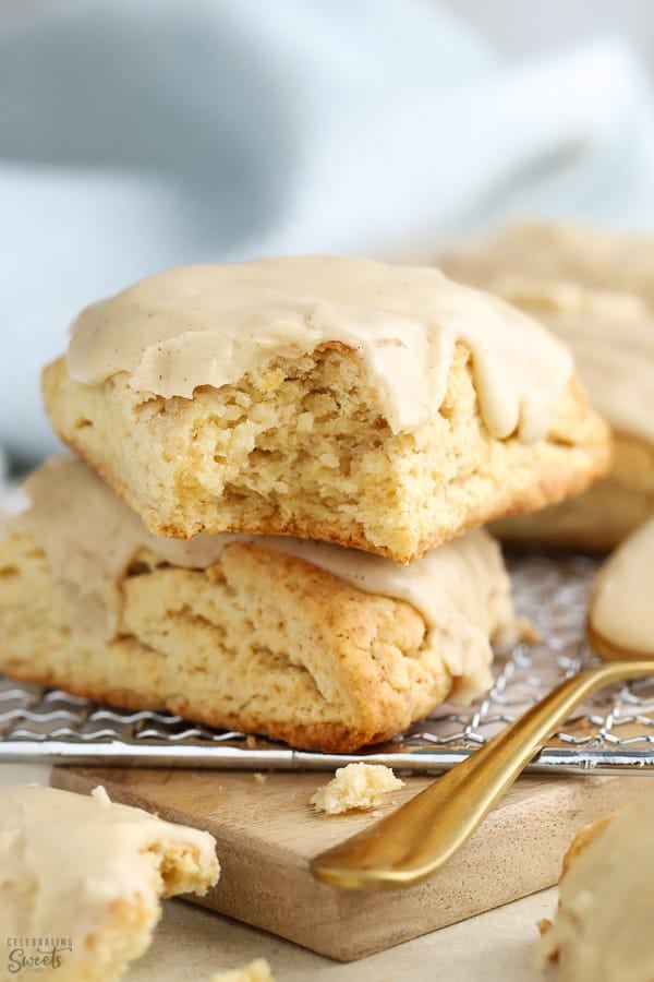 Two maple scones on a wire rack. 