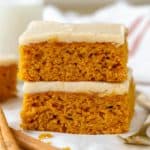 Stack of pumpkin bars on parchment paper.