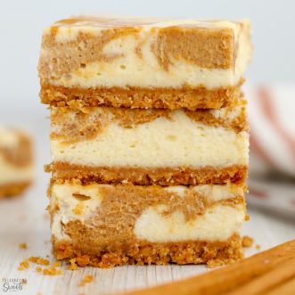 Stack of pumpkin cheesecake bars.