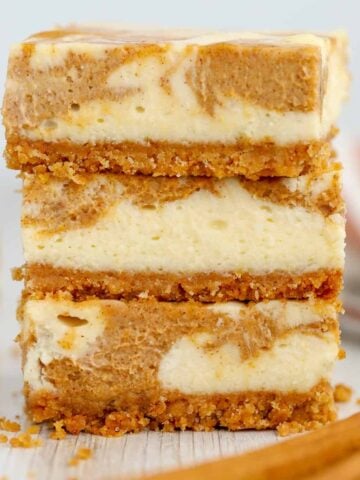 Stack of pumpkin cheesecake bars.