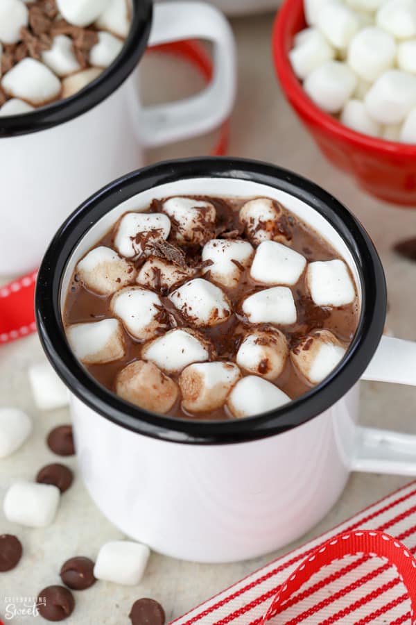 Hot chocolate in a white mug topped with marshmallows.