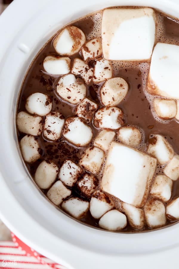 Hot chocolate in a crock pot topped with marshmallows.