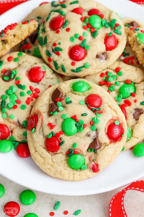 Christmas cookies on a plate with red and green sprinkles and candies