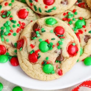 Christmas cookies on a plate with red and green sprinkles and candies