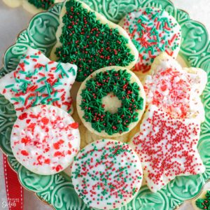 Christmas cut out cookies on a green plate
