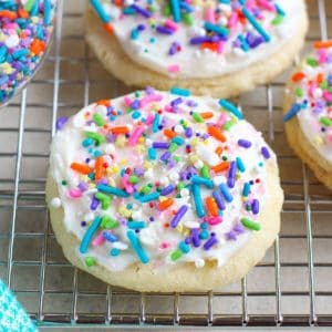Sugar cookies topped with frosting and sprinkles