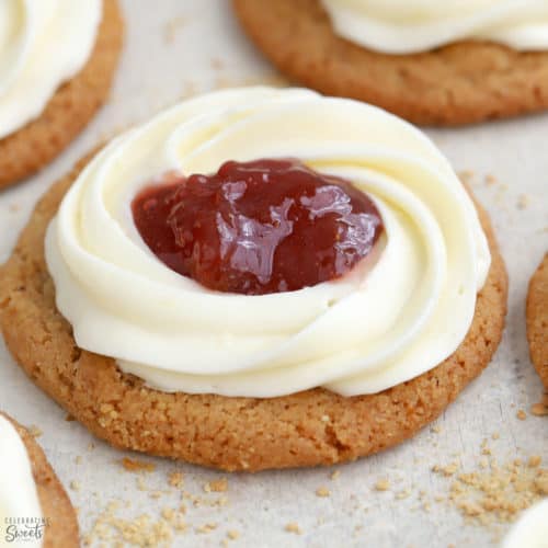 Cheesecake cookie with a swirl of frosting and jam in the center