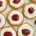 Cookies topped with cram cheese frosting and jam