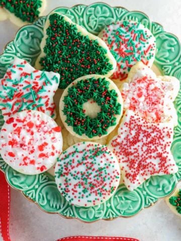 Cut out Christmas cookies on a green plate