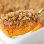 Close up of sweet potato souffle on a gold spoon
