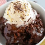 Chocolate pudding cake in a bowl with vanilla ice cream