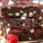 Stack of brownies with raspberries and white chocolate