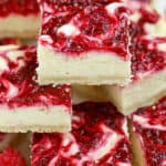 Stack of white chocolate raspberry cheesecake bars