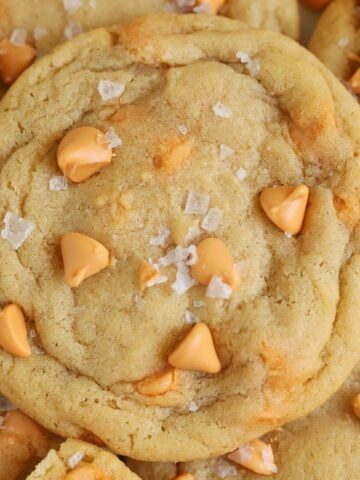 Closeup of a butterscotch cookie topped with flaky sea salt.