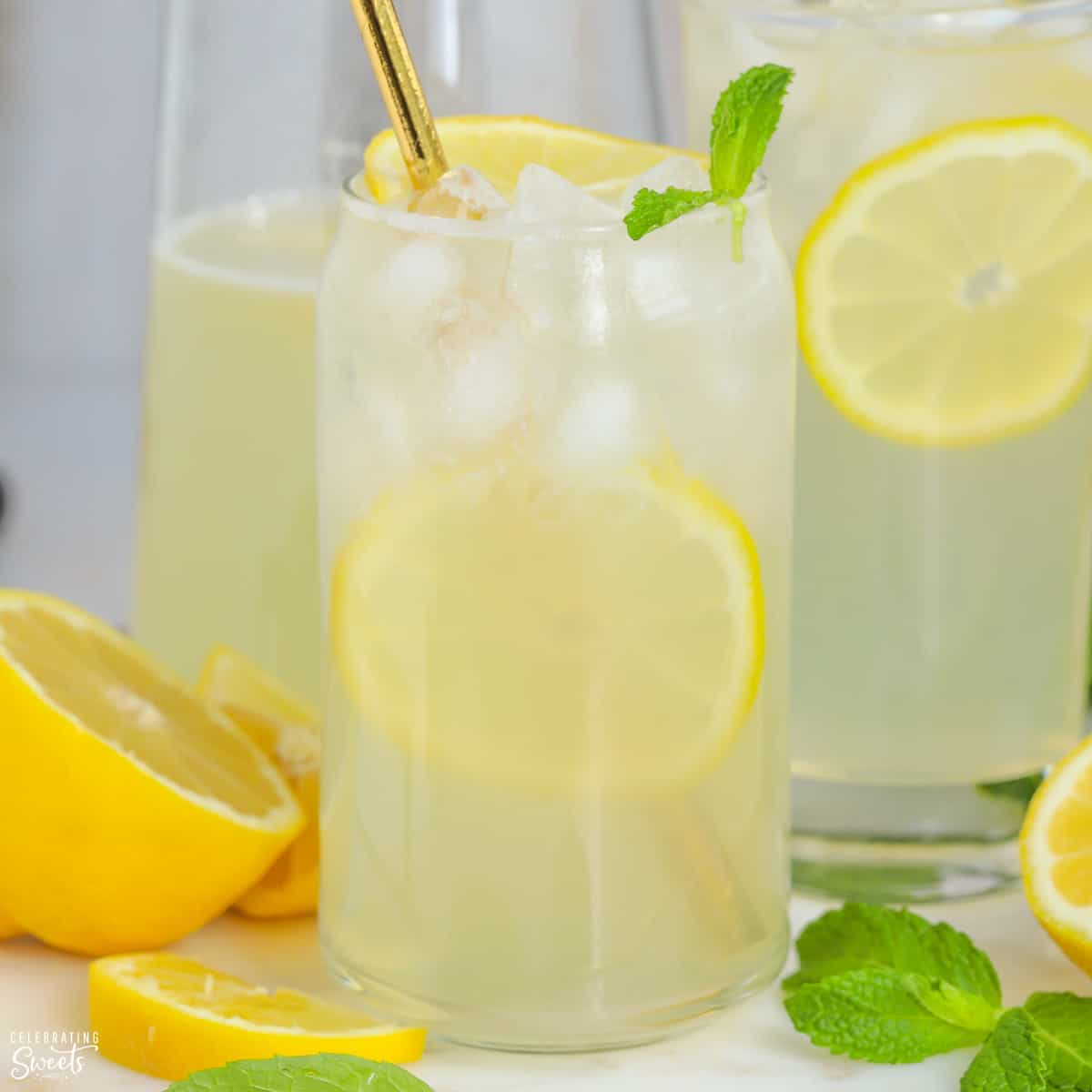 Glasses of lemonade garnished with lemon slices and mint.