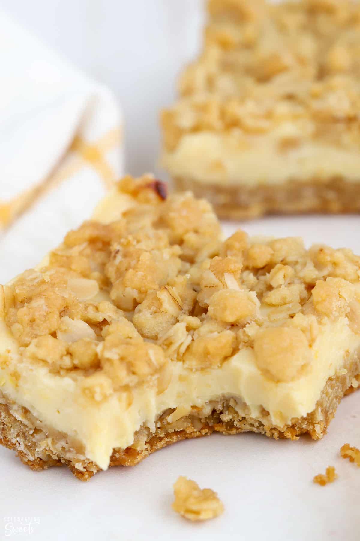 Close up of lemon crumb bars with a bite taken out of it