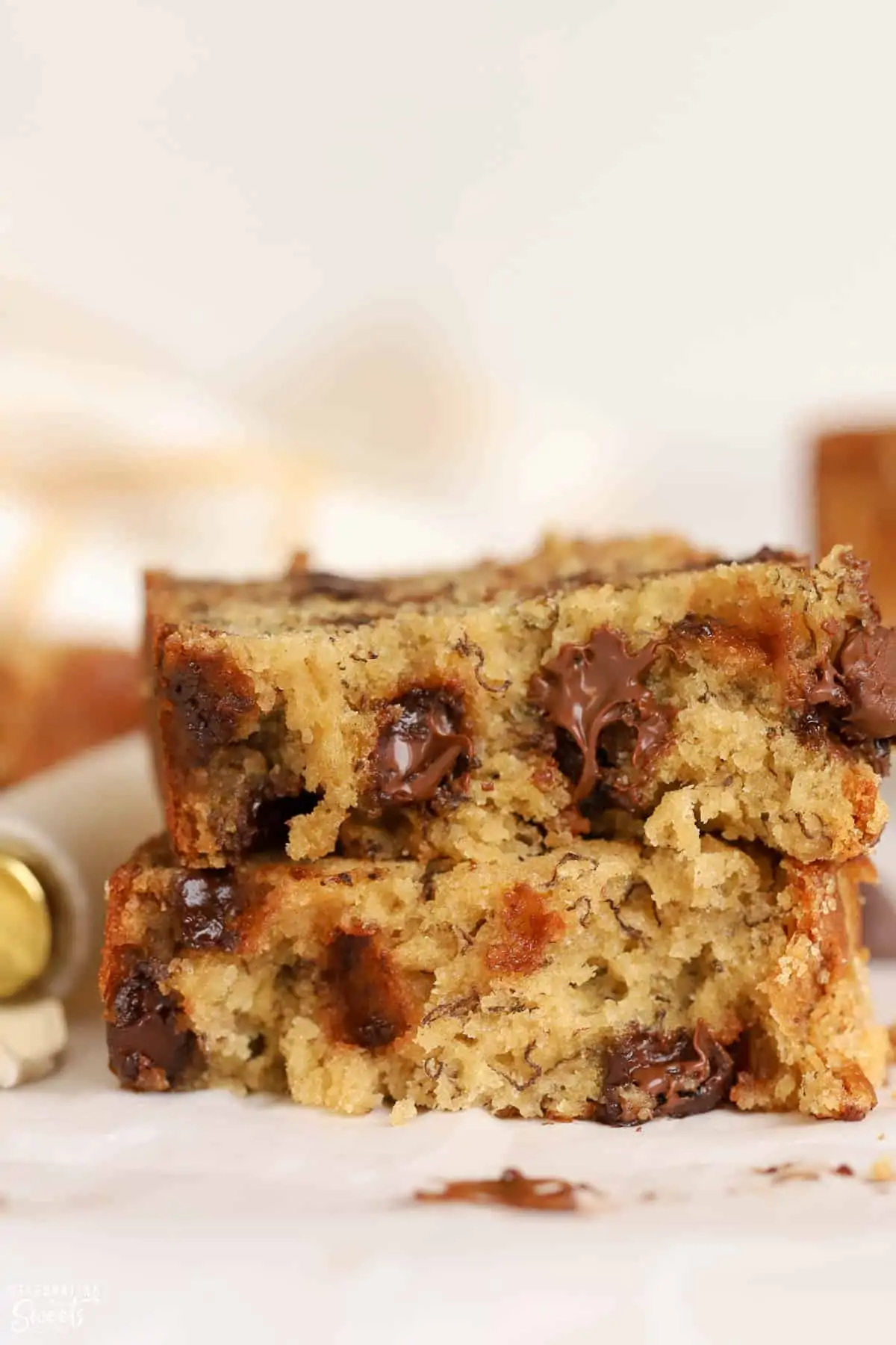 Closeup of a slice of banana bread filled with chocolate chips.