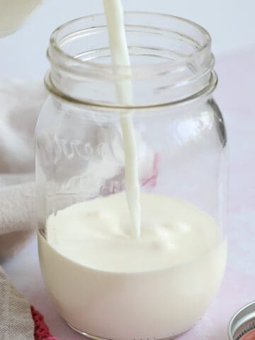 Milk being poured into a jar