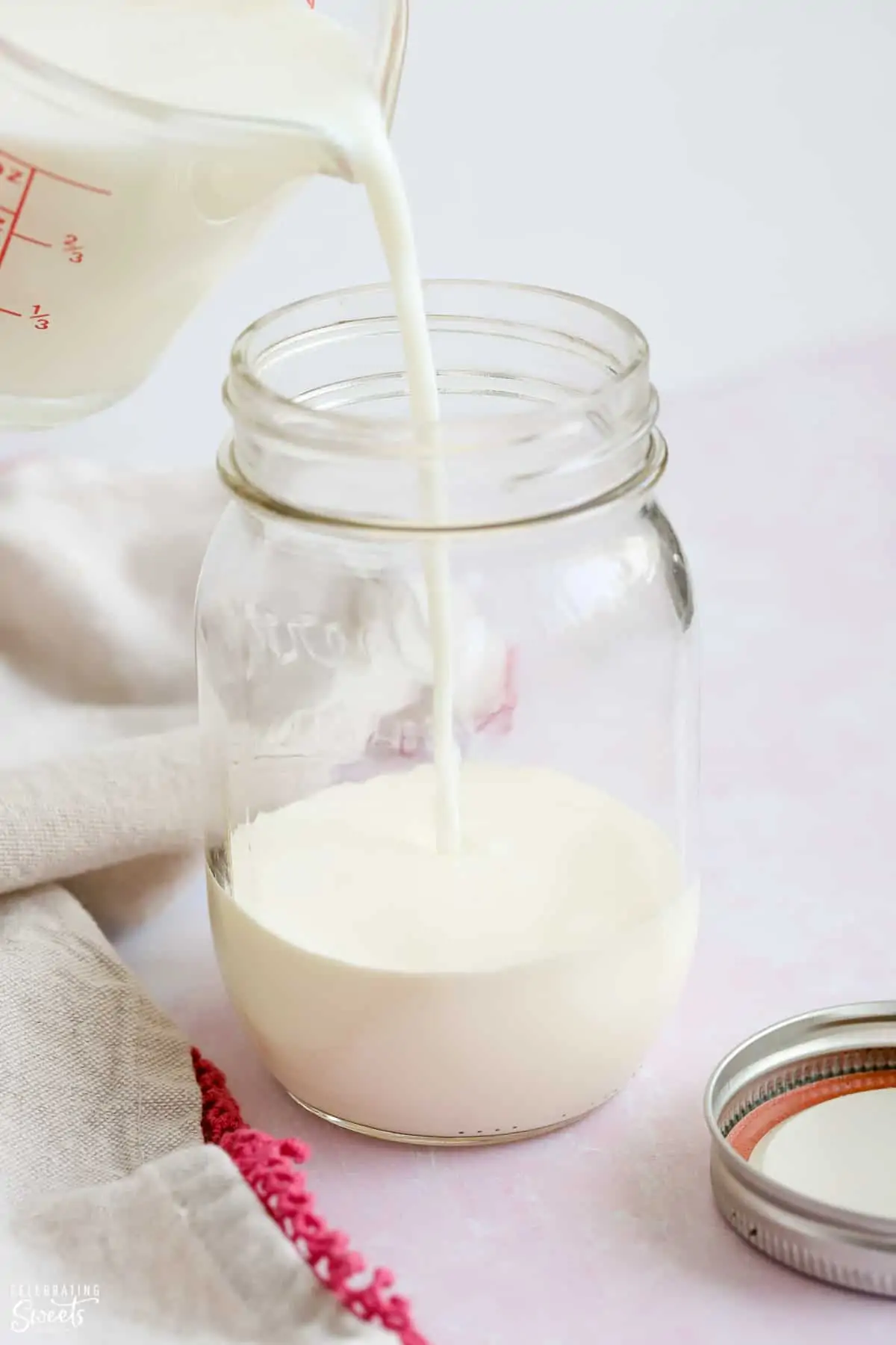 Milk being poured into a jar
