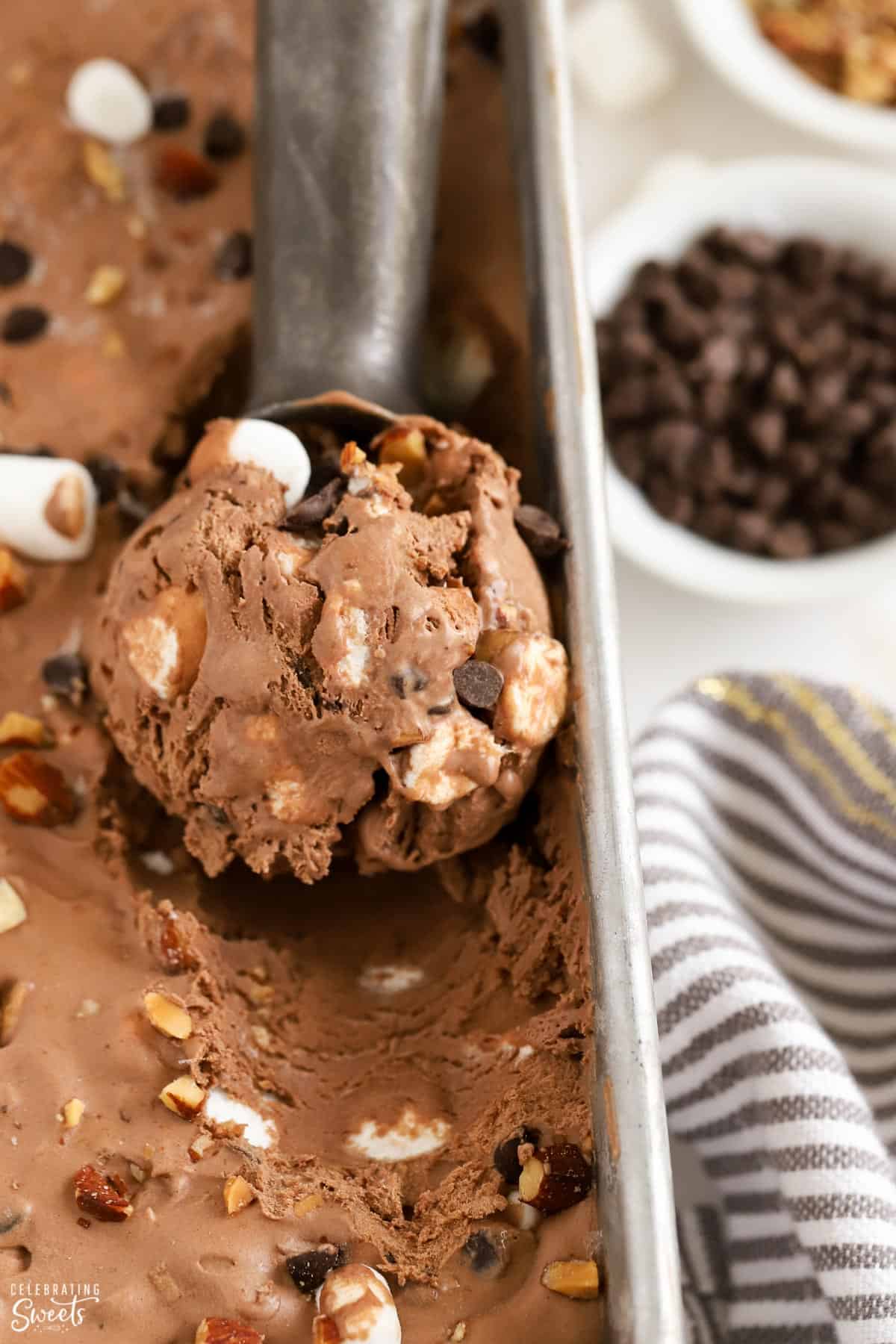 Scoop of rocky road ice cream in a loaf pan.