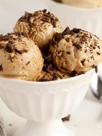 Coffee Ice Cream in a white bowl topped with chopped chocolate.