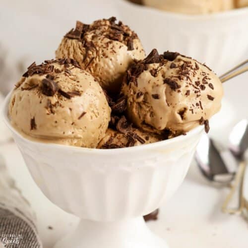 Coffee Ice Cream in a white bowl topped with chopped chocolate.