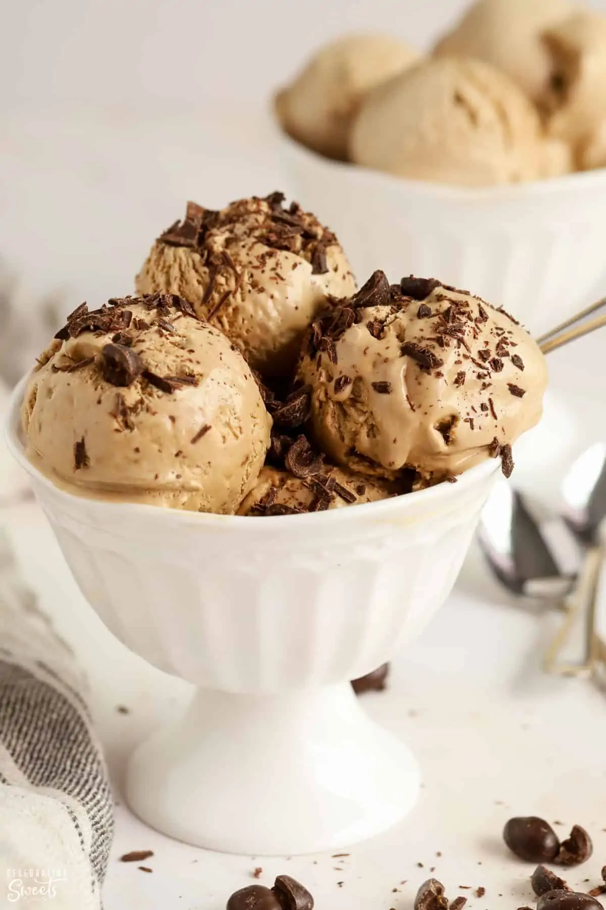 Coffee Ice Cream in a white bowl topped with chopped chocolate.
