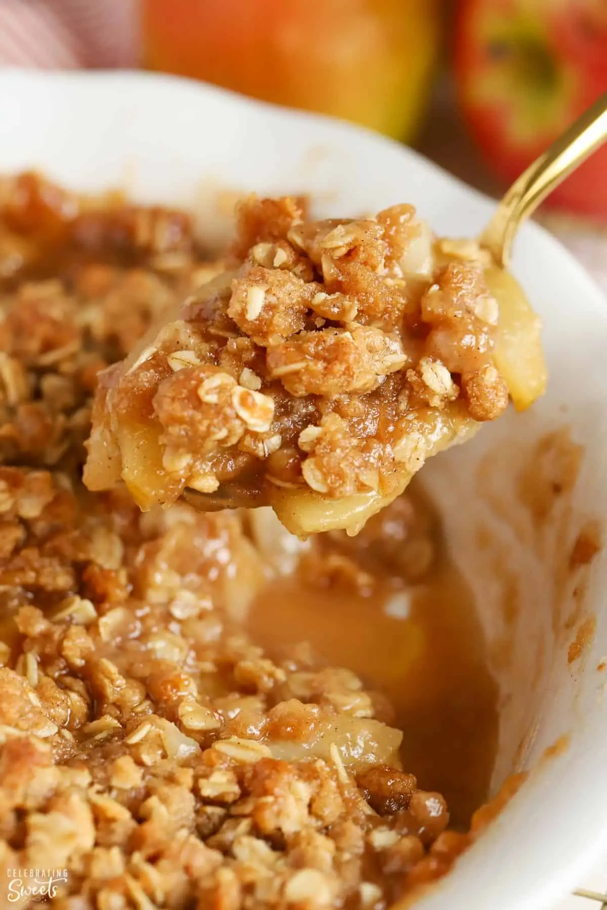 Scoop of apple pear crisp on a gold spoon.