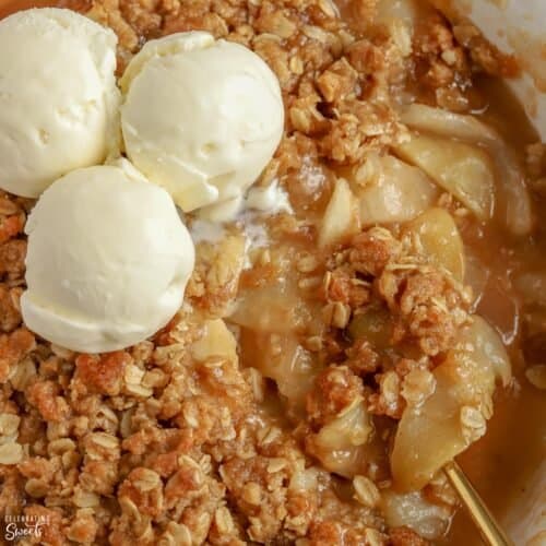 Closeup of Apple Pear Crisp topped with scoops of vanilla ice cream.