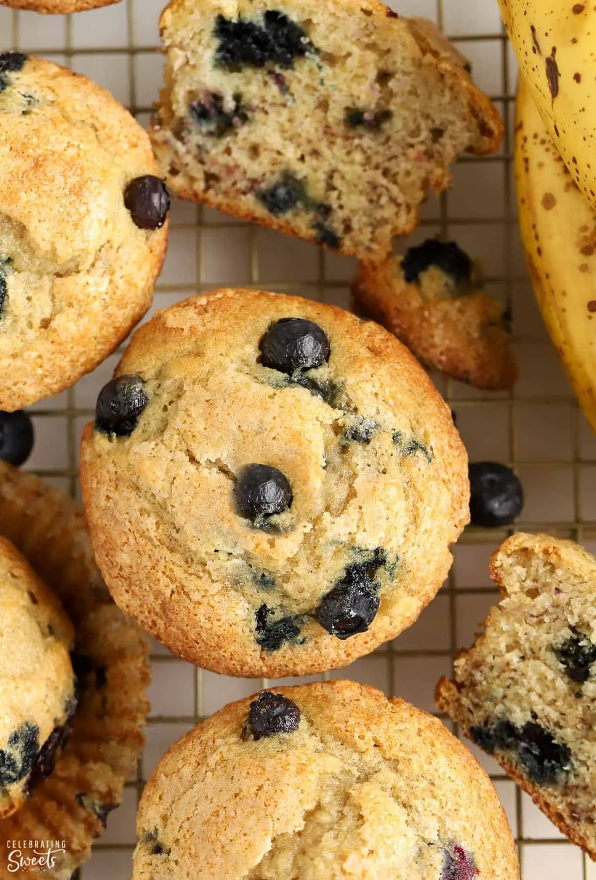 Overhead shot of blueberry banana muffins on a wire rack.
