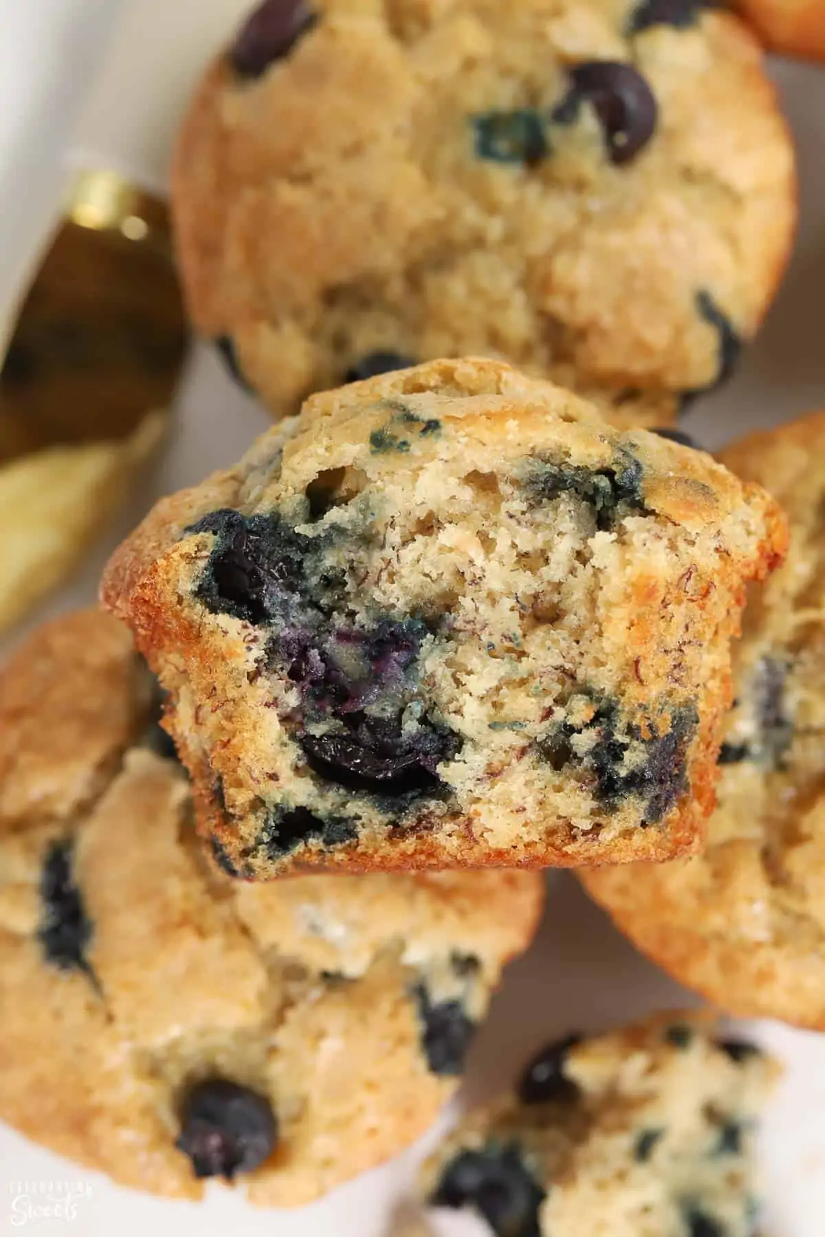 Closeup of blueberry banana muffin with a bite taken out of it.