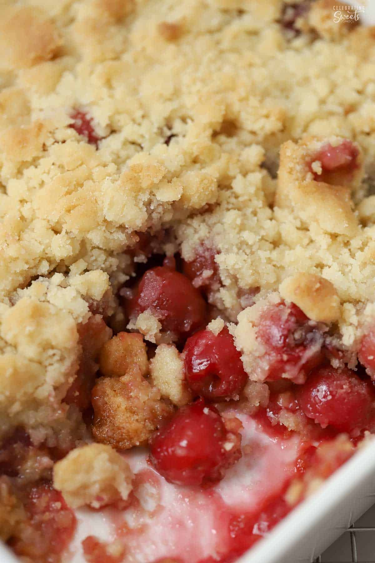 Cherry cobbler in a white baking dish.