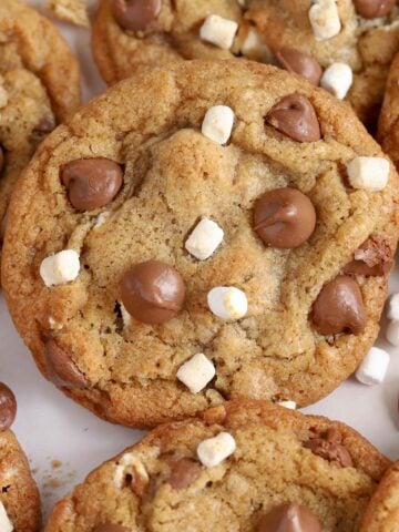 Closeup of s'mores cookies topped with chocolate chips and marshmallows