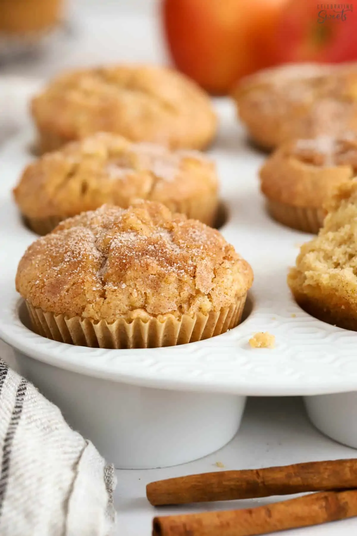 Apple cinnamon muffins in a white muffin baking dish.