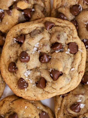 Closeup of espresso chocolate chips cookies topped with flaky sea salt.