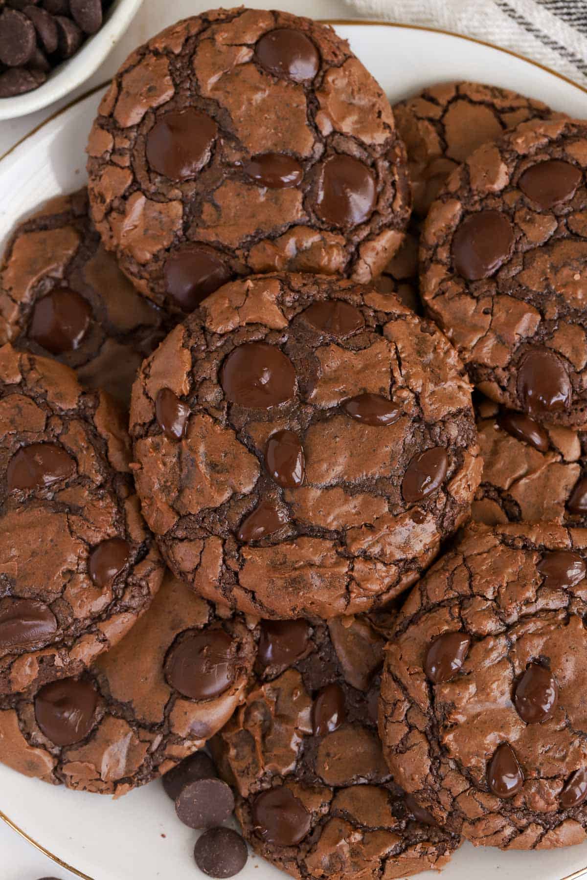 Pile of brownie cookies on a white plate.