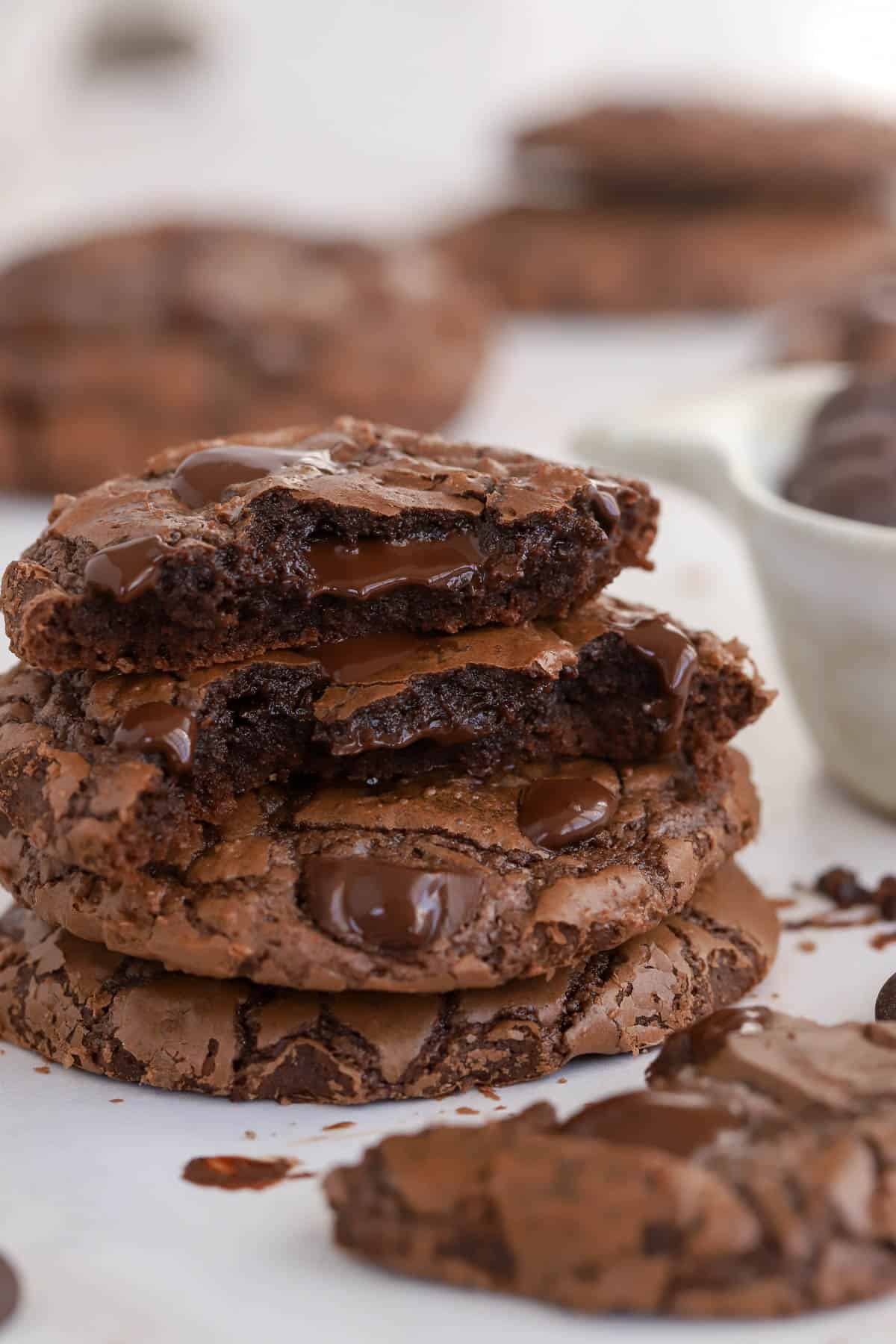 Stack of three brownie cookies with melty chocolate chips.