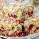 Stack of slices of cranberry cake on a grey plate.