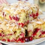 Stack of slices of cranberry cake on a grey plate.