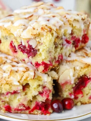 Stack of slices of cranberry cake on a grey plate.