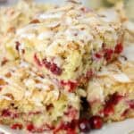 Three slices of cranberry cake stacked on a grey plate.