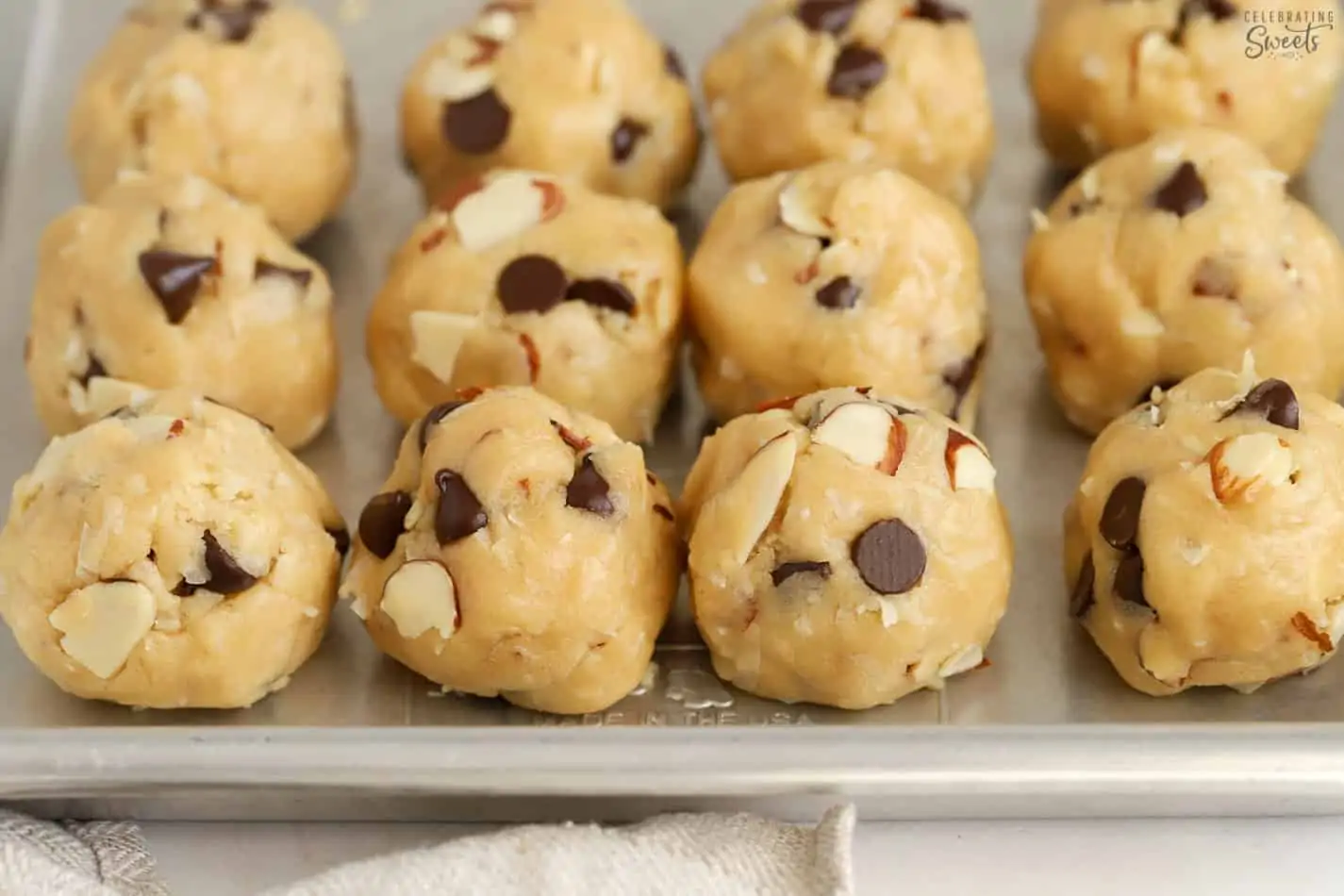 Almond joy cookie dough balls on a baking sheet.