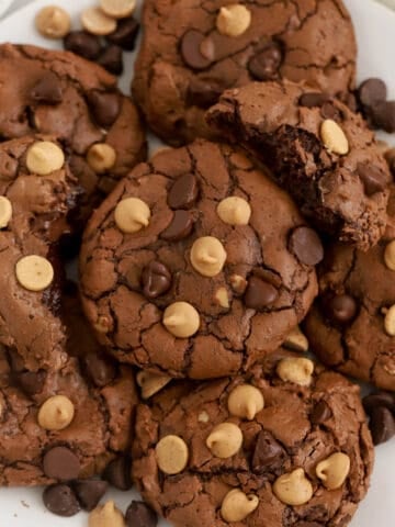 Peanut butter brownie cookies on a white plate.